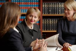 Tribunal member and staff reviewing a file